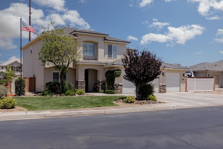 Welcome to your dream home in Saint George, Utah! This immaculately maintained two-story residence boasts sophisticated living with 5 bedrooms and 3.5 bathrooms across a spacious layout. Step inside to find elegant hardwood floors flowing through a welcoming entryway into a cozy yet open living area complete with stylish fixtures and ample natural light. The heart of this home is its gourmet kitchen featuring modern, dark cabinetry, granite countertops, and stainless steel appliances, perfect for cooking and entertaining. Connected is a charming dining space overlooking the manicured backyard. Retreat to the expansive master suite which includes a luxurious bathroom with a soaking tub, separate shower, and dual vanities. Additional bedrooms offer flexibility for family, guests, or a ho
