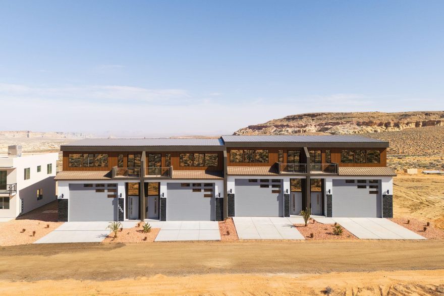 YOUR LAKE POWELL ADVENTURE HEADQUARTERS!
Units are offered as a ''gray shell'' — a blank canvas ready to finish to your taste. Each features 1,637 sq. ft. of garage/storage (14x16 door, 55 ft deep) — perfect for boats, RVs, and toys — plus 1,358 sq. ft. of upper-level living space with high ceilings and a covered patio. That's nearly 3,000 sq. ft. total for your Lake Powell retreat or investment property. Nightly rental approved — imagine storing your boat and having your upper level pay for it!