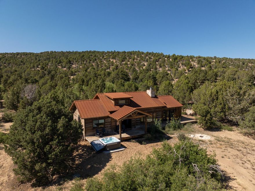 Peach's Cabin Lodge 223 - A Luxury Rustic Escape situated on a sprawling, wildlife-rich property just outside Zion's East entrance.
Set on nearly two private acres at 6,000 ft elevation, Lodge 223 blends upscale comfort with timeless mountain charm. Accommodating up to 10 guests, the cabin offers five beds across two thoughtfully designed levels, a vaulted loft, and a stone fireplace anchoring the inviting living space. Modern amenities pair seamlessly with warm wood and natural stone finishes. Outside, a spacious deck with plush seating, a hot tub, and a fire pit creates the ultimate setting for starlit evenings. Just minutes from Zion National Park, this refined rustic retreat offers serenity, seclusion, and an unforgettable connection to nature. Active STR Peaches at Zion Mountain Ranch is situated on approximately 300 acres of rugged, serene wilderness, this guest ranch sits ideally near Zion National Park's eastern entrance. A portion of the property includes a 600-acre buffalo preserve, allowing visitors to view roaming bison right from their cabin doorstep.
Guests enjoy an authentic western experience in private cabins and lodges crafted with rustic, reclaimed finishes and modern comforts. This isn't just a place to sleepit's an experience. Enjoy guided hikes, canyoneering, horseback riding, jeep tours, and nightly campfires under some of the clearest night skies in Southern Utahideal for stargazing. Plus, the property supports rich wildlife encountersvisitors often spot deer, rabbits, and of course, bison.

The ranch is a standout home-base for exploring not just Zion, but also Bryce Canyon, the North Rim of the Grand Canyon, Grand Staircase Escalante, Cedar Breaks, and Lake Powellall within comfortable driving distance.