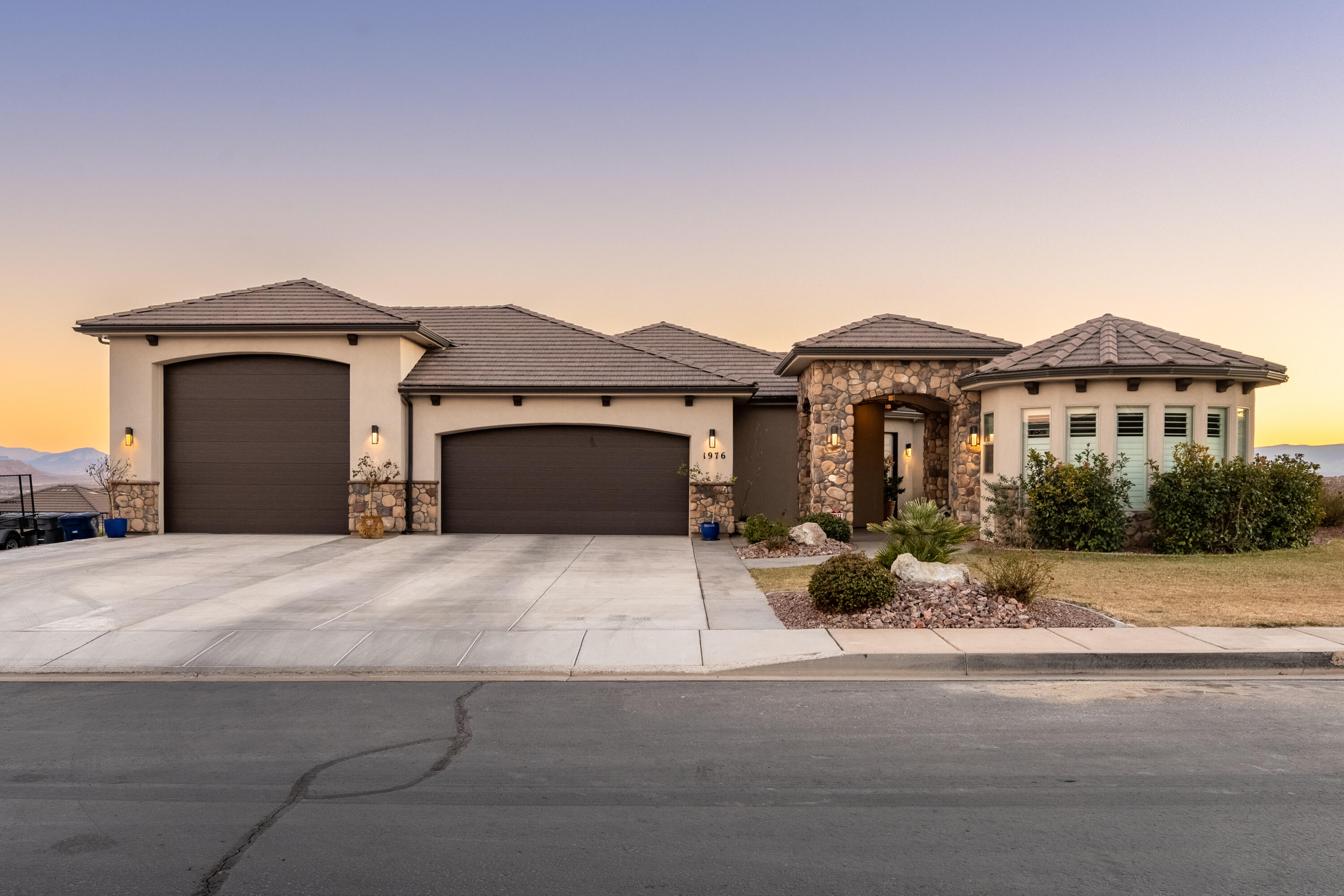 Welcome to this stunning Southern Utah Home! Step inside to discover an expansive, open-concept living space bathed in natural light, perfect for both relaxation and entertaining. The modern kitchen with sleek white cabinetry is complimented by black stainless-steel appliances, a stylish backsplash, and a generous island with bar seating. A built-in sound system enhances the ambiance, seamlessly connecting the living room to the inviting back patio with beautiful views of the Valley. 

A detached 1-bedroom casita sits at the front of the property, offering private yet convenient access, featuring a kitchenette, 3/4 bath, and stackable laundry hookups.
The luxurious primary suite offers a peaceful spa-like en-suite, complete with dual vanities and an oversized walk-in shower. Enjoy ample storage with a spacious closet and an attached laundry room with hallway access. 

The oversized RV garage is a standout feature 17.2' wide by 35.8' deep, with a 14' x 14' door, epoxy floors, and an on-demand water heater.

Downstairs, a second primary suite offers privacy with an en-suite bathroom with dual vanities, soaking tub, walk-in closet, and an additional kitchenette along with two more generously sized bedrooms, each with its own attached bathroom, provide ample space and comfort complimented with a separate exit to the backyard, where you will find spa hook-ups and a pad stubbed with natural gas. 

Located in a tranquil neighborhood just minutes from parks, shopping, dining, and more, this home offers contemporary luxury living in beautiful St. George. Make it yours today!
Buyer to verify all information.