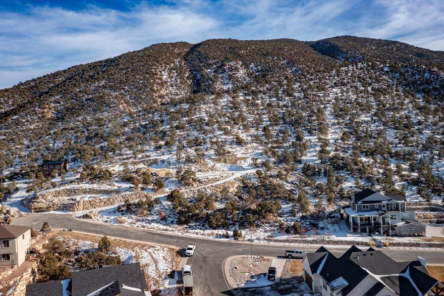 Set at over 6,100 feet in elevation, this is one of the highest—and most scenic lots in Cedar City. Located in the peaceful Ashdown Forest subdivision, this 2-acre pad-ready wooded property offers incredible views of the Cedar Valley and surrounding mountains. The lot features private hiking and deer trails, natural overlook points, and a peaceful setting perfect for evening walks. It's also less than 1,000 feet from the public trails in Fiddlers Canyon, offering some of the area's best nature walks right out your door. The land has been thoughtfully improved, with multiple cleared and excavated areas ideal for a greenhouse, garden, workshop, or detached garage. A home site pad has already been cut, with minimal fill used and good soil compression, making it easier to start your build. Take a drive up the private road to the top of the property and take in the viewsit's a location that truly needs to be experienced in person. 

Cedar City is one of the most beautiful cities. It is home to Southern Utah University and the Shakespeare Festival, as well as some amazing restaurants. As part of Southern Utah, you will experience a lifestyle like no other. The area features nearby internationally recognized mountain biking trails, road cycling, hiking, golf courses, national parks such as the Grand Canyon, Zion, & Bryce, national moments, national forest, reservoirs, & some of the most iconic desert landscapes in the world. Less than an hour away from Brian Head Ski Resort, there is no doubt that this is a fun place to live and play.

All information herein is deemed reliable but is not guaranteed. Buyer is responsible to verify all listing information, including square feet/acreage, to the buyer's own satisfaction.