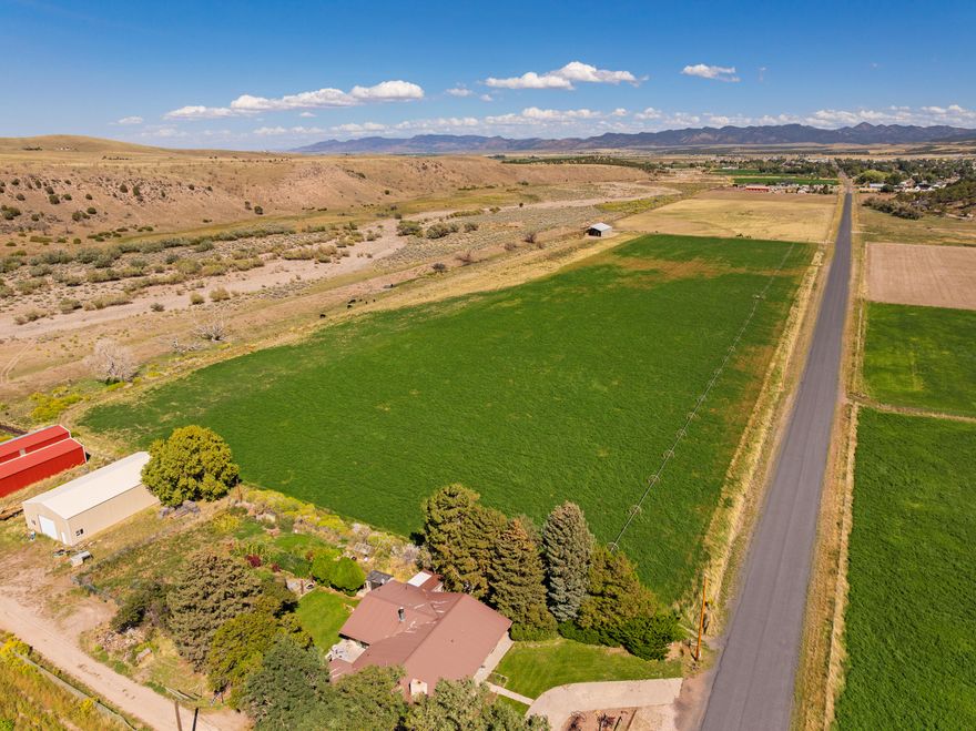 184.77 acres for sale in city limits in Enterprise, UT. Currently being farmed. Includes 174 shares of Enterprise Reservoir and Canal Company. Water shares are being used to irrigate Southwest 15 acres of land currently. Southeast 30 acres are currently set up for dry farming/grazing. Power is located on the property. Hay barn (85x55) and wheel lines are included in the sale. Currently being assessed in Greenbelt for taxes. Build a residential home and keep farming the land. 

Other possibilities include developing a residential subdivision with 45 acres on the South flat land. Developers would have to bring city utilities from the nearest connection to the property. So many different ideas and opportunities with this land. Come and see it.
