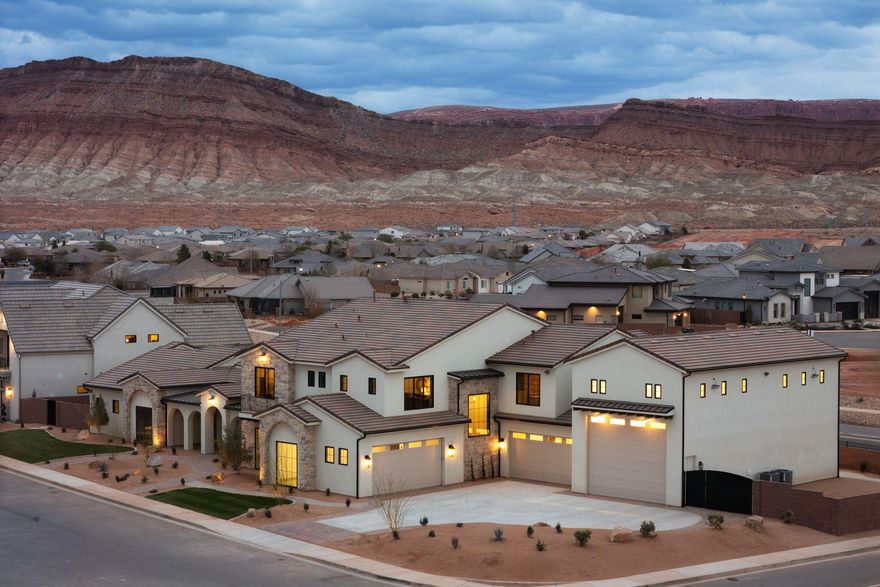 Introducing Playa Del Sommer, a stunning 2026 Parade Home built by Slate Ridge Homes, offering nearly 9,000 square feet of refined indoor and outdoor luxury living in one of Washington's premier communities. Designed to showcase exceptional craftsmanship, timeless Spanish-inspired architecture, and cutting-edge smart home technology, this residence sets a new standard for Southern Utah luxury.

The thoughtfully designed floor plan features 7 bedrooms, 8 bathrooms, and expansive entertaining spaces, including a dedicated theater room, game room, bunk room, and a grand great room with seamless indoor-outdoor flow. Each bedroom suite is designed for privacy and comfort, making the home ideal for hosting guests, multi-generational living, or luxury retreat-style living.

The gourmet chef's kitchen is equipped with professional-grade appliances, custom cabinetry, oversized walk-in pantry with additional refrigeration, and premium stone surfaces, creating the perfect environment for both daily living and large-scale entertaining.

Step outside to your private resort-style backyard featuring:
" In-ground resort style swimming pool and spa
" Expansive outdoor living and entertaining areas
" Professionally designed landscaping
" Space for future sport court or recreation amenities

Luxury upgrades and features throughout include:
" Custom cabinetry and handcrafted millwork
" Lutron smart home automation system
" Integrated whole-home audio and Dolby Atmos theater sound
" Security camera system
" Custom luxury lighting package
" Multiple fireplaces including statement feature fireplace
" Designer stone and tile selections
" Automated window coverings and garage systems

Car enthusiasts and storage needs are fully covered with an impressive 6-car garage configuration and flexible storage spaces.

Built with exceptional attention to detail and premium materials throughout, Playa Del Sommer offers a rare opportunity to own a true showpiece home combining Spanish elegance, modern luxury, and resort-style living all located near golf, dining, outdoor recreation, and everything Southern Utah lifestyle living has to offer.