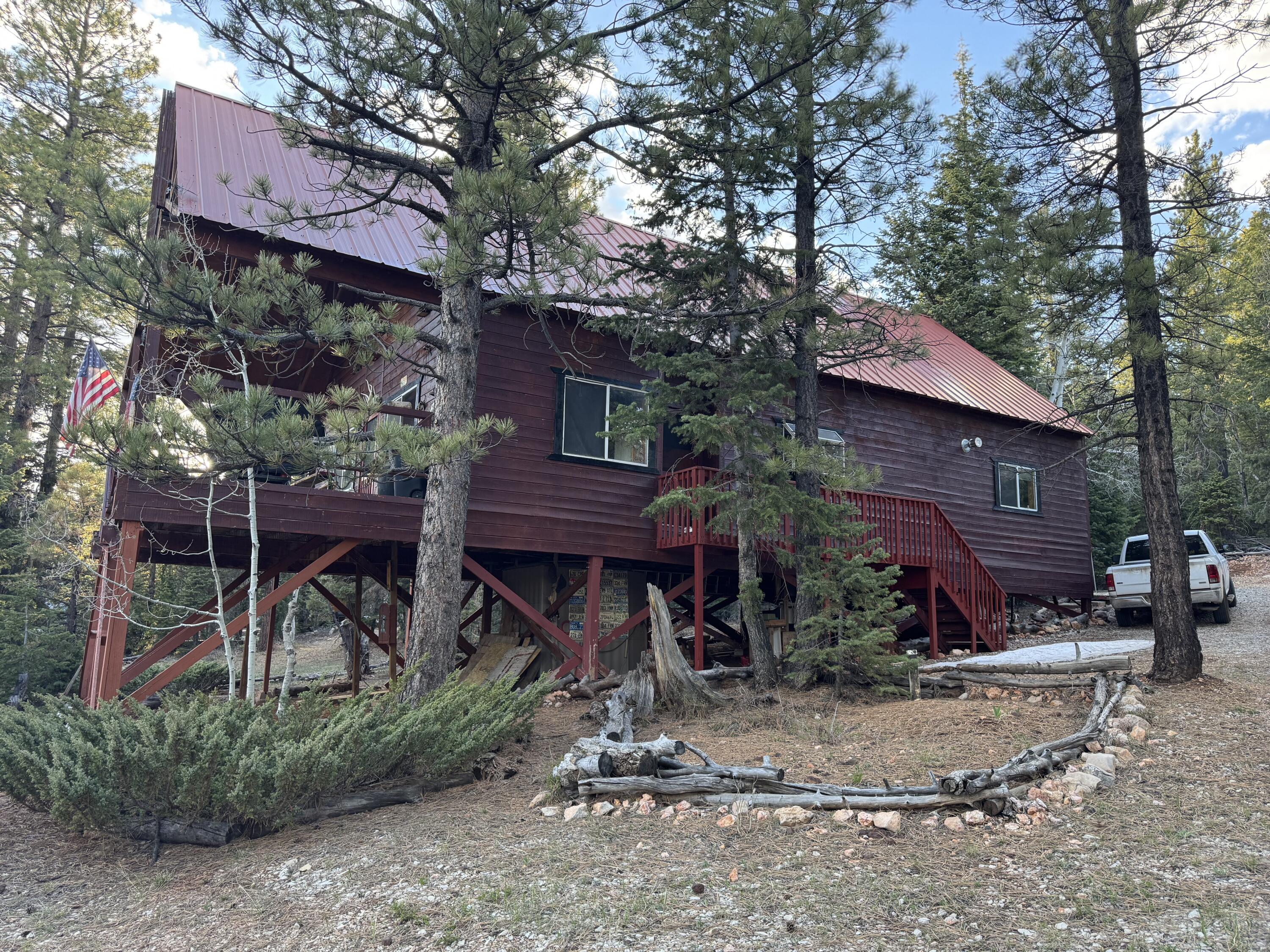 Escape to the tranquility of Duck Creek Village, with this inviting 3-bed, 1.5 bath cabin nestled on a quiet street in Zion View Mtn Estates subdivision. Built in 1994 and sitting on a spacious .37-acre lot, this 1746 sq ft retreat offer comfort, privacy, and true cabin feel in a peaceful mountain setting. Enjoy the beauty of nature on the large, covered deck. Water meter and septic already installed. Open living with warm wood accents, a functional kitchen, and plenty of space for family and guests. Just minutes from scenic trails, fishing, and recreational activities, this property provides the perfect balance of seclusion and accessibility. Don't miss the opportunity to own a slice of mountain paradise in Duck Creek Village, UT.