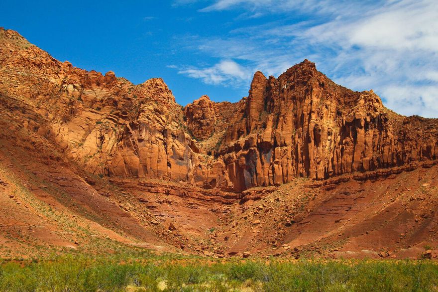 Red Desert is an exclusive gated community on 10 acres bordering the Red Cliffs Desert Reserve, the Red Cliffs National Conservation Area, and Snow Canyon State Park. Being located next to this beautiful backdrop affords the opportunity to transform your home into a one-of-a-kind work of art by incorporating the surrounding views deep inside the interior of your home.
Red Desert is nestled along the sculpted Palisades Cliff formations of the Red Mountain/Snow Canyon Corridor. The enchanting views available to Red Desert encompass the States of Arizona to the south, Nevada to the west, and Utah in the foreground.
The northern boundary of Red Desert directly borders the Red Cliffs Desert Reserve, Snow Canyon State Park, and the Red Cliffs National Conservation Area. Any access within the Reserve including hiking, biking, or horseback riding is strictly prohibited and is restricted to the Reserve's designated "Toe Trail" located several hundred feet north of Red Desert.
In addition to the privacy and security provided by the Entrance Gate, sandstone colored privacy walls exist along the south, east and west property boundaries of the Development. More importantly, the minimal fencing along the Reserve to the north allows for unmatched views of Red Mountain.