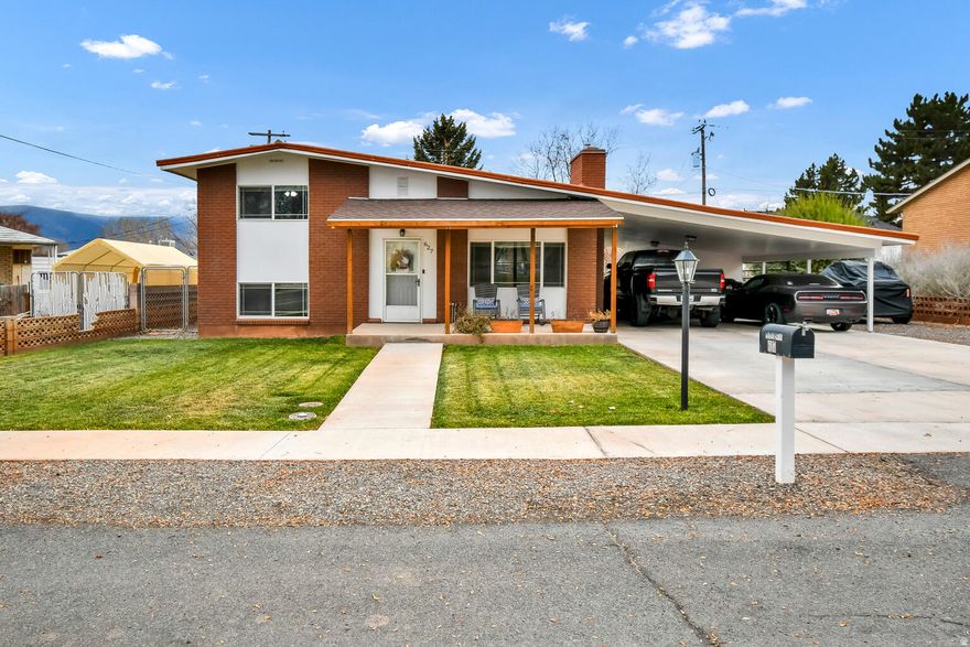 Welcome to this beautifully maintained 1,536 sq. ft. 3-bedroom, 2-bathroom split-level home in an unbeatable location. As you enter, you're greeted by a warm and inviting family room centered around a cozy gas fireplace, creating the perfect gathering
space for family and friends. Just a few steps away, the updated kitchen features quartz countertops and stainless steel
KitchenAid appliances, offering a clean space ideal for everyday living. 
The storage area under
the carport is locked, but has 2 built-in workbenches inside. Relax on the covered front porch and enjoy the stunning
mountain views, and take advantage of the convenient 1012 sq. ft. carport that provides year-round protection and easy parking.
The fully fenced backyard provides a private outdoor retreat with a covered patio perfect for entertaining or unwinding. A heated
storage area with a built-in workbench adds even more versatility for tools, projects, or hobbies. Situated directly across from a
city park with baseball fields and a community pool, just blocks from the high school, and positioned at the base of the mountain
with access to miles of ATV trails, this home offers a rare blend of comfort, convenience, and outdoor adventure. This is a
property you won't want to miss!