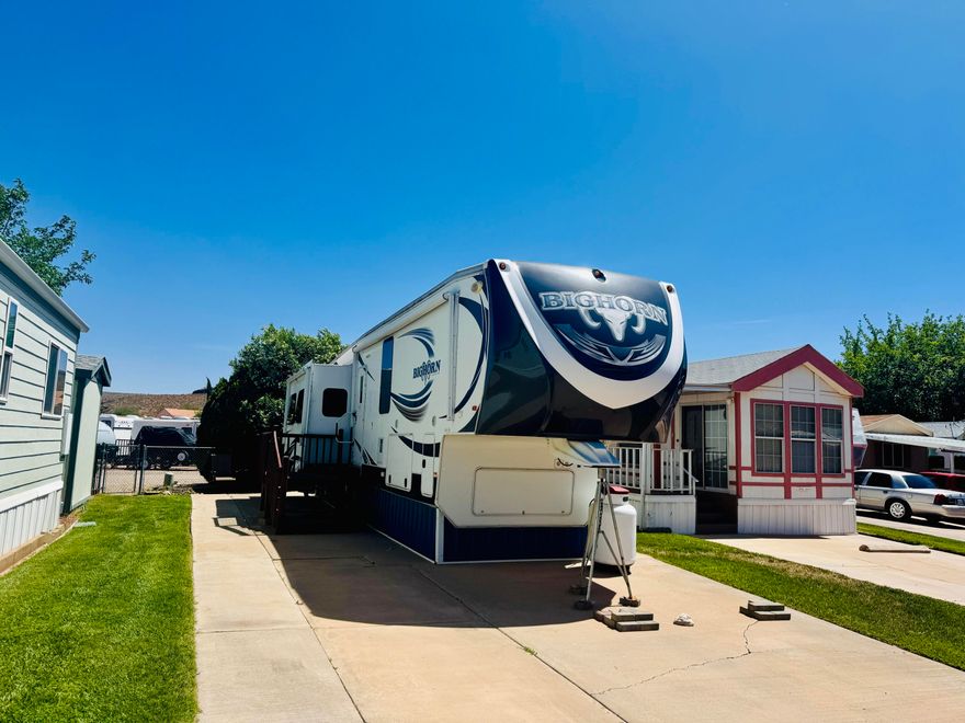 Spacious lot with a beautiful green backdrop along the backyard fence, offering added privacy and a peaceful setting. Includes a 6x6 shed for extra storage.
Lot includes a 2014 42' Montana fifth wheel with 3 slides. This luxury model comes fully furnished and features a fireplace, 2 TVs, double refrigerator, and a comfortable living area with a hide-a-bed couch. Offers 1.5 baths, including an oversized master bath with a step-in shower. Washer/dryer hookups add extra convenience. Ample storage underneath and a newer king-size mattress make this the perfect place to relax and enjoy resort-style living. Located in a highly desirable RV park featuring 2 clubhouses, a pool, hot tub, and a variety of fun community activities. Buyer to verify all information.