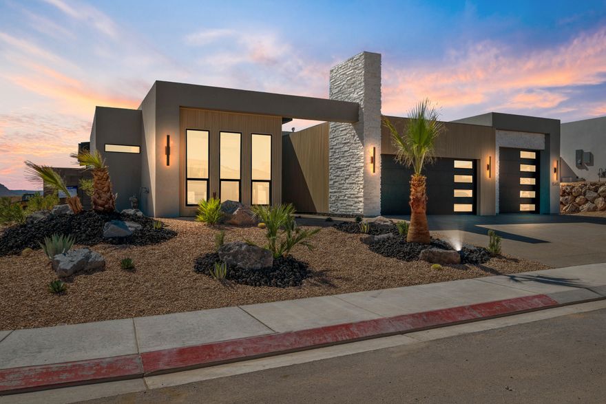 Another masterpiece by Urban Desert Homes, the perfect blend of modern comfort and outdoor living - appraised at $1,130,000. The heart of the home features floor-to-ceiling kitchen cabinets and a built-in gas range for the cooking enthusiast. The living room captivates with its back-lit feature wall and cozy gas fireplace. The spacious primary suite includes a covered patio, spa like shower, and custom built-ins in the his and hers closets for ultimate organization. The second bedroom boasts an en suite bathroom and walk-in closet, ensuring comfort for family or guests. Sealed epoxy garage floors, low maintenance landscaping with artificial turf in the backyard means more time for adventures at nearby Sand Hollow State Park and Zion National Park.