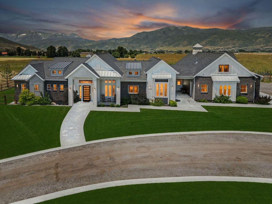 6.11 acres Home, Horse Property & INDUSTRIAL (Industrial is approximately 3 acres of the 6.11 acres) located within the Enterprise Zone offering potential tax credits & brimming with possibilities for storage units, development or business opportunities.
Nestled in the heart of Heber City, Utah, this stunning horse property offers breathtaking views of majestic Mt. Timpanogos. The expansive modern home features 3 spacious bedrooms with en-suite bathrooms, a large Gym plumbed for a bathroom (could be another bedroom with en-suite bath), office with built in cabinetry, family/game room with kitchenette, large pantry/storage room both upstairs and downstairs, a powder bathroom & mud/locker room and a massive laundry room with more storage, an extra large 4-car garage. Above the garage, unfinished charming Accessory Dwelling Unit (ADU) provides an additional bedroom, bathroom, and is plumbed for a kitchen, perfect for guests or rental income.
Irrigation for your garden or mini farm. 3 water shares included, 21 additional water shares available for purchase.

Just minutes from Heber City Airport, two pristine reservoirs, and world-class ski resorts, this estate combines rural serenity with unparalleled convenience. Embrace the ultimate Utah lifestyle with this extraordinary property.  

Home, acreage & industrial acreage must be sold with the industrial land, it will not be sold separately and is priced accordingly.  

See document section for more details about the Enterprise Zoning and Zoning Map. Additional land may be available inquire with listing agents for more details.

The following items are not included and will be removed by the Seller: Sauna, Hot Tub, Chicken Coop, all containers and equipment.
Home is available to show on short notice, proof of funds or pre-qualification letter required for all showings.