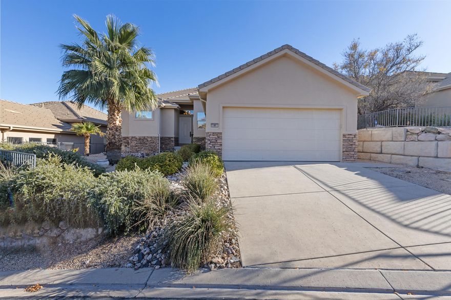 Discover this beautifully maintained St. George home featuring spacious high ceilings and a well-designed floor plan that offers comfort and flexibility. With three master suites, everyone enjoys privacy and convenience. Take in the stunning views of the surrounding mountains, wide-open vistas, the golf course, and a large pond filled with local wildlife—all from your covered deck. Tucked away on a quiet street with wonderful neighbors, this home captures the peaceful, scenic lifestyle St. George is known for.