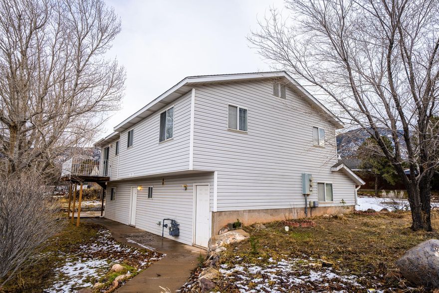 Income Producing Duplex. Recently remodeled up-down duplex near SUU rents for $2800/mo. Main level 3bd/2ba with balcony and spacious living room. Basement has separate entrance 1bd,1bath apartment. 
New swamp cooler, all new paint, new flooring LVP and tile, all new appliances on main level, main kitchen remodeled. Basement bathroom redone, along with new finishes throughout.