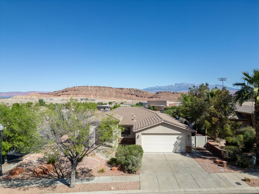 Elevated corner-lot home with panoramic red rock and Pine Valley views that truly steal the show. No HOA. Completely remodeled and move-in ready, this home leaves nothing untouched: fresh paint, updated light and bathroom fixtures, tile flooring, stylish backsplash, brand new appliances, and more! Featuring a functional, 4 bedroom floorplan on one level that instantly feels like home. Enjoy a low maintenance yard with mature landscaping. Unwind under the shaded pergola while you take in gorgeous mountain views. On Dixie Power. Fantastic location near schools, hiking, restaurants, golf, and easy access to I-15. This is one you definitely won't want to miss!