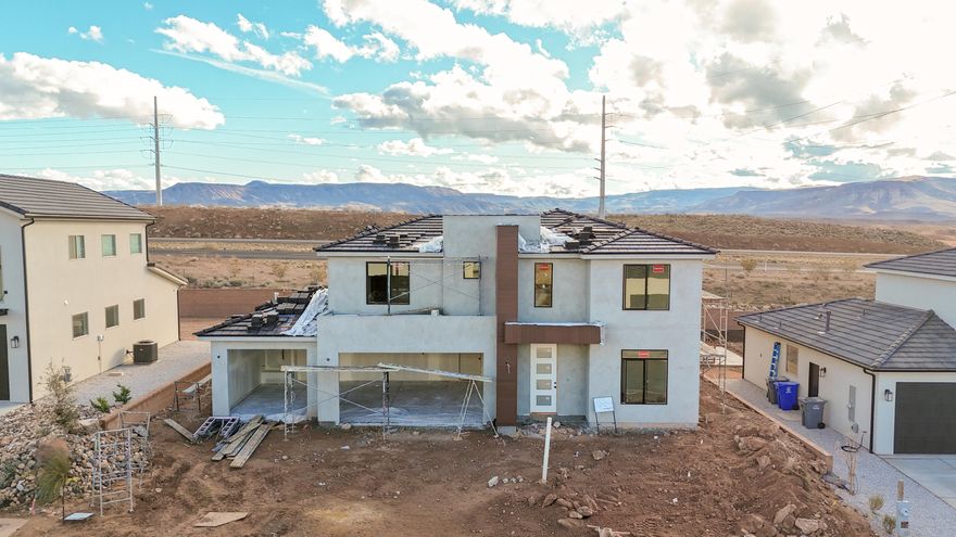 Modern 4-bedroom home with a den, 3.5 bathrooms, and a 3-car garage. Features a spacious second living area upstairs, plus a main-level primary suite with an upgraded bathroom and freestanding tub. The grand kitchen includes painted cabinets, upgraded flooring, and countertops (refrigerator not included). Large backyard with no rear neighbors. Located near the Arizona border, no HOA, and just 10 minutes from the new Smith's Marketplace. Ask about available lender incentives. Buyer and agent to verify all information. Photos are examples of the finishes are also subject to change.