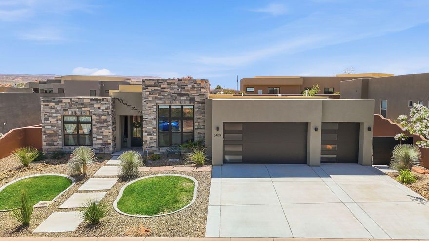 Welcome to elevated desert living in the highly sought-after Dunes at Sand Hollow Resort. This beautifully customized home blends warmth, comfort, and luxury with an inviting open-concept design, thoughtfully upgraded interiors, and expansive windows that flood the space with natural light.

Designed for both relaxation and entertaining, the spacious covered patio creates the perfect setting for indoor-outdoor living, complete with large sliding doors that seamlessly bring the outdoors inside. The oversized yard offers endless possibilities with room for a pool, putting green, or your own private backyard retreat.

The attention to detail continues into the garage with a stunning epoxy-coated floor that adds both durability and a polished finish. But the true showstopper is the incredible rooftop deck featuring breathtaking 360-degree views of the golf course, Zion, and Pine Valley Mountains. Whether you're entertaining guests, enjoying a sunset, or watching fireworks under the stars, this rooftop oasis is an unforgettable bonus space.

Living at Sand Hollow Resort means embracing the ultimate Southern Utah lifestyle. HOA dues include front- and back-yard maintenance, allowing you to toss the lawnmower and spend more time enjoying everything this incredible community has to offer. Residents receive discounts at both the Championship and Links golf courses, along with savings at the clubhouse dining and pro shop.

From peaceful walks to the reservoir and hiking among the red rocks to side-by-side adventures and world-class golfing, outdoor recreation is truly at your doorstep. This is more than a home -- it's a lifestyle.