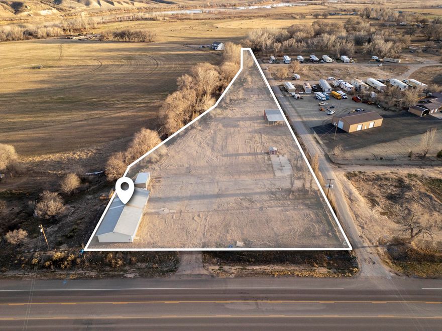 Step into your own adventure retreat or homestead, ideally located as a gateway to some of Utah's most iconic landscapes. Just one-third mile from the Green River, enjoy convenient access to fishing and rafting, including the renowned Gates of Lodore with Adrift Dinosaur, located less than a mile away.  Dinosaur National Monument is approximately five miles from the property, offering unique experiences like the famous Wall of Bones and scenic Split Mountain Gorge. Nearby McCoy Flats Trail Complex provides miles of non-motorized trails for hiking and biking with routes suited to a variety of skill levels.  Red Fleet State Park, often called a 'mini Lake Powell,' features a walkable dinosaur trackway along with boating, fishing, and camping opportunities. Flaming Gorge Reservoir, about forty-five minutes away, is widely known for exceptional fishing, including lake trout, kokanee salmon, and rainbow trout.  The property includes approximately 3.8 acres with a barn and a 2,500 square foot building ready for your vision. There are garden areas and space suitable for agricultural use. Buyers are encouraged to verify potential uses, including livestock allowances, with local authorities.  Enjoy a more peaceful setting while still being within about twelve miles of Vernal, which offers medical services, shopping, dining, and recreational amenities, including museums and a recreation center.  Acreage and building sizes are approximate. The property consists of two separate parcels with electricity, water, and sewer systems present. Buyers should consult with Uintah County Building and Planning. The seller and listing agent provide information to the best of their knowledge but make no warranties, express or implied. Buyers are responsible for independently verifying all zoning, permitting, and building requirements.