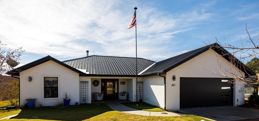 Completely reimagined, remodeled, this stunning 3-bedroom, 3 bath home combines modern upgrades and exceptional curb appeal. The fresh white stucco exterior paired with a striking black metal roof creates a crisp, high-end look. Inside, a beautiful dining area surrounded by large windows, and fully remodeled kitchen features elegant quartz countertops, while luxury LVP flooring flows seamlessly throughout the home for a clean, cohesive feel. The inviting living space includes a charming wood stove, creating a warm atmosphere. The attached garage features a new insulated garage door, a modern side-mount opener for maximum overhead clearance, and an electric vehicle charger. Step outside to a fully landscaped yard that has beauty and functionality. The white fencing and sequoia tree serves as a stunning focal point. Flowering and fruit trees enhance this yard, creating a peaceful setting to enjoy. The large patio includes an electric hookup, ready for you to a hot tub and create a private retreat with a storage shed as well. This property is for buyers seeking comfort, efficiency, and lasting value. Buyer to verify all.