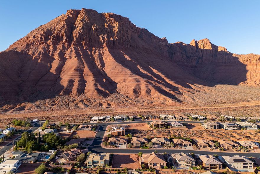 Bring your own builder to this rare view lot —an opportunity that's becoming increasingly hard to find in Ivins, Utah. Design and build the home you've always envisioned while enjoying unobstructed views of the Red Mountain, Snow Canyon, and the city lights of St. George. This premium homesite is just minutes from the Red Mountain Wilderness Trailhead and the scenic Toe Trail trailhead, offering easy access to hiking, biking, and even walking to Tuacahn Amphitheatre. You'll also be just around the corner from the prestigious Black Desert Golf Course, where championship golf, dining, and world-class amenities enhance the already remarkable Southern Utah lifestyle. With the Washington County Water Conservancy District impact fee already paid and an HOA transfer fee of $350, this lot combines convenience, value, and location in one.