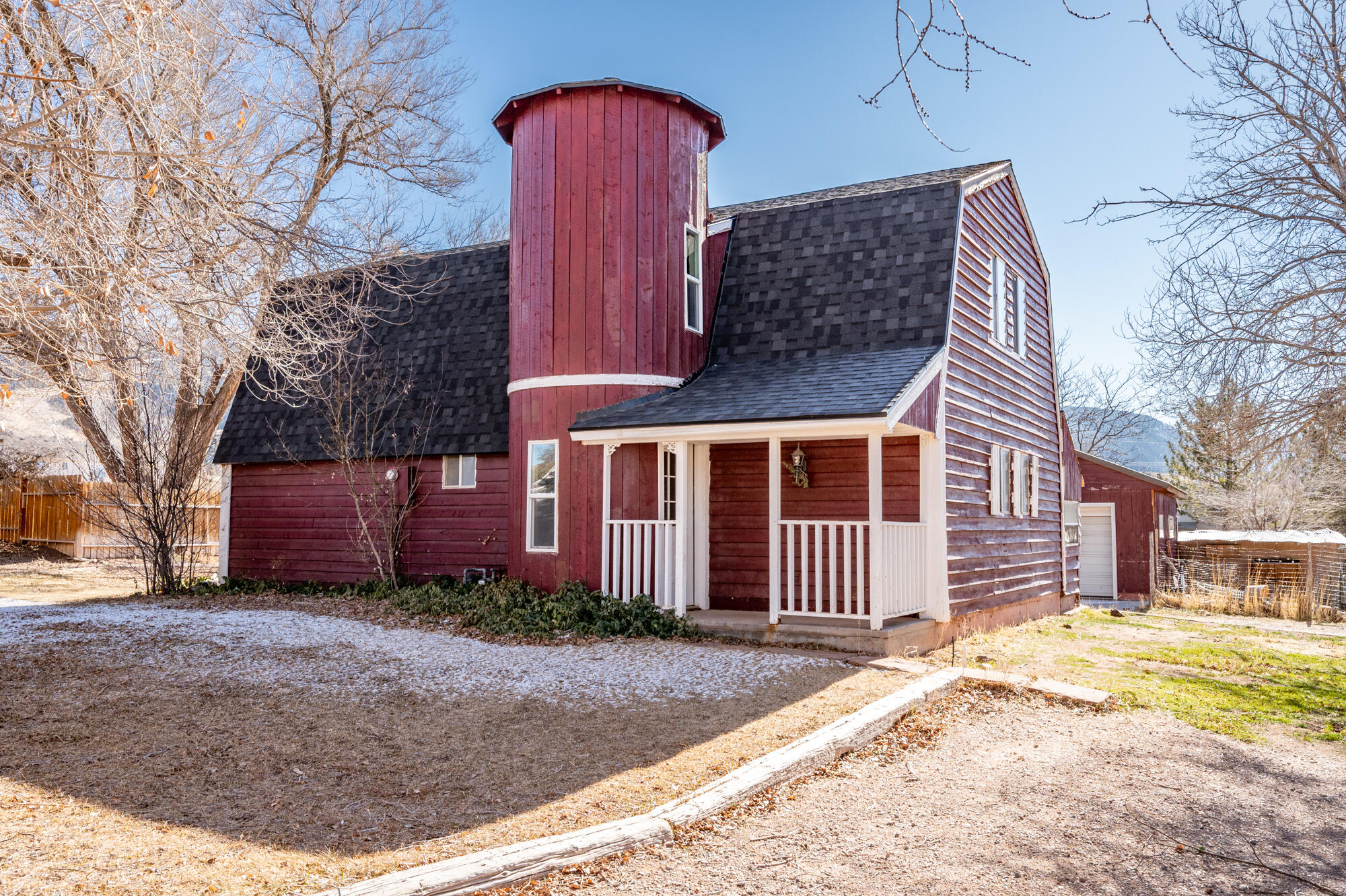 Explore this barn-style home that sits on just over half an acre of land on a corner lot. Property comes with fruit trees, a powered shed for your projects, plenty of gardening space, and the freedom for your animals to roam. Home uses a portable swamp cooler.