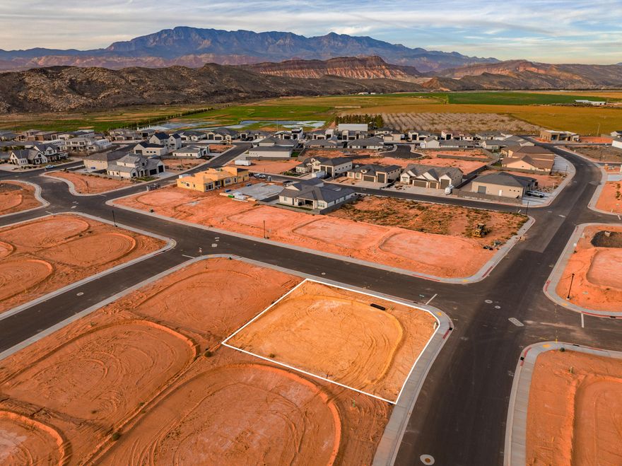 A short RZR ride from Sand Hollow Reservoir and the sand dunes, adventure starts at your garage door. Lot 63 is an elevated corner view lot. Build your home base for adventure in Phase 2 of Sand Hollow Village. This lot was made for people with toys—ideal for a modest home with a massive RV garage. Keep your camper, boat, side-by-side, Jeep, and motorcycles...all the gear...on site and skip the storage unit. A place to launch big weekends, unwind after long days outside, and settle in for the long haul—whether you're growing a family or easing into retirement. Friendly, clean neighborhood with sensible CC&Rs that protect quiet enjoyment. No snooty HOA. All builders welcome. Call for an introduction to a home builder. We've been waiting for you.