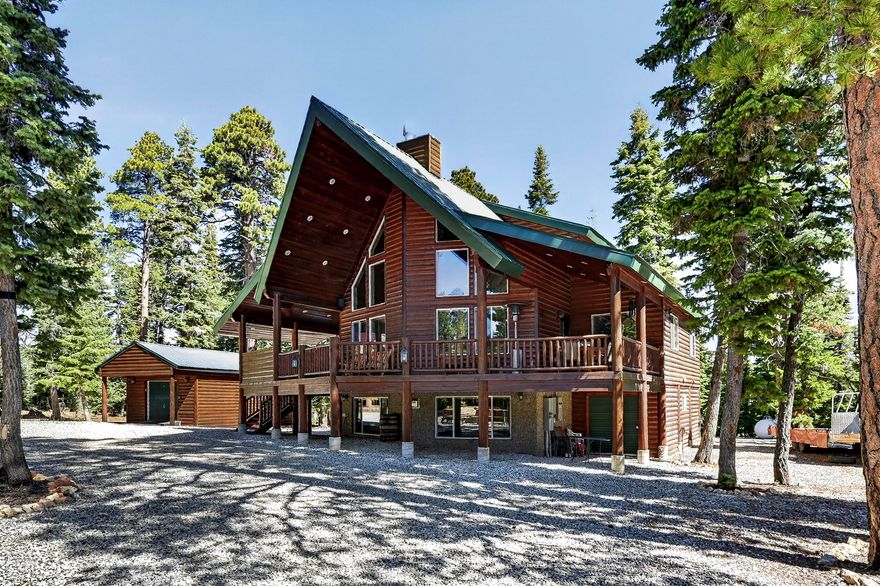 Located in the desirable Meadow View Heights subdivision, this impressive mountain retreat sits on .54 acres and offers 3,198 sq ft with 5 bedrooms, multiple living spaces, and incredible indoor and outdoor entertaining areas. The inviting entrance welcomes you into a warm cabin feel with beautiful tongue and groove finishes, vaulted ceilings, and large windows that bring in natural light throughout. The spacious great room features a stunning rock fireplace and dry bar that flows into the kitchen and dining area complete with a walk-in pantry and plenty of room for gathering. The loft area is currently used as an office but offers flexibility for additional sleeping space, a game area, or whatever fits your needs. The primary suite includes its own rock fireplace, private deck access, dual vanities, a separate tub and shower, and a spacious layout perfect for relaxing after a day on the mountain. The main level laundry room offers additional cabinets, shelving, a sink area, and extra storage space. The lower level offers an ideal entertainment setup with another large family room, a rock fireplace, a dry bar area, and plenty of room for guests and gatherings. Outside, enjoy the covered deck with a built-in BBQ and outdoor kitchen area overlooking the trees, plus a custom firepit area with surrounding benches perfect for evenings in Duck Creek. The property also includes an oversized detached 2-car garage with high ceilings, upper storage area, and an energy-efficient mini-split system providing both heating and cooling, along with an additional outbuilding/workshop ideal for ATVs, toys, and extra storage. Additional property features include a newer Generac whole-home generator with automatic transfer switching, an upsized propane tank, full RV hook-ups, a Kinetico water softener system, and a reverse osmosis water filtration system. Located in a great area close to year-round recreation, trails, and all Duck Creek has to offer. Some furnishings, electronics, appliances, ATVs and snowmobiles are negotiable upon acceptable offer.
