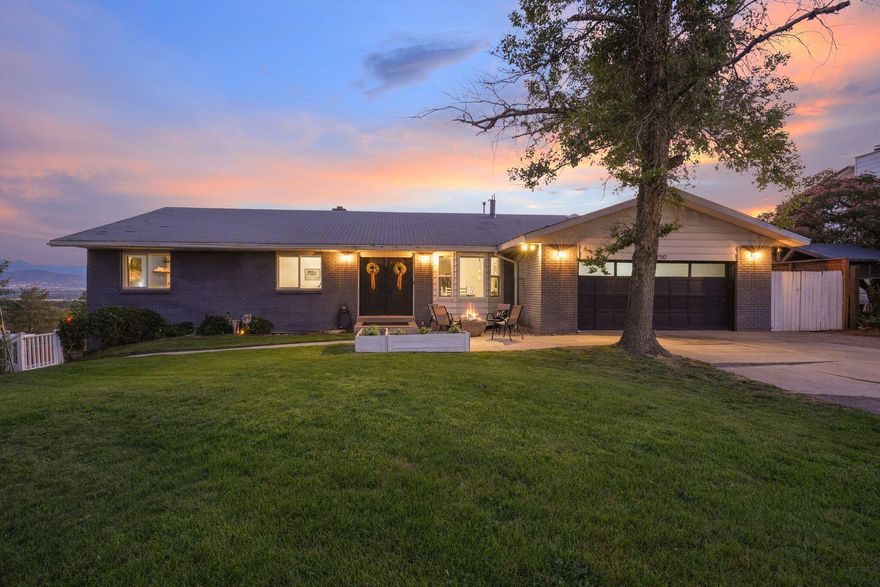 This sprawling home offers ample space for everyone! Ideal for multigenerational living with its 7 bedrooms and 4.5 baths. The separate basement entrance provides independence, featuring a second kitchen, family room, 4 bedrooms, bath and laundry facilities, making it ideal for extended family or guests. On the main level, the open floor plan creates a sense of flow and spaciousness. Large windows frame stunning valley and mountain views, while a cozy fireplace adds warmth to the space. The spacious main level kitchen is equipped with a double oven, gas cooktop, and breakfast nook that overlooks the valley views. The primary bedroom is a serene retreat with breathtaking city views, fireplace and updated ensuite bath featuring custom tile walk in shower. The backyard is a private oasis, complete with a patio and large deck perfect for entertaining and enjoying the views. Located in a highly desirable area on East Bench in Sandy, just below Little Cottonwood Canyon, this home offers easy access to nearby parks, trail, shopping centers and more!