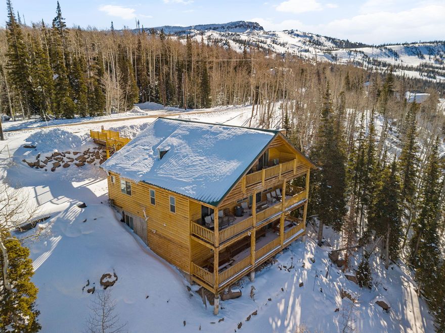 Beautifully updated three-level mountain cabin in Brian Head, just minutes from the ski slopes, offering the perfect blend of comfort, versatility, and mountain charm. Set on over half an acre with no HOA and year-round access via a paved, county-maintained road, this property is ideal as a full-time residence, second home, or nightly rental. The thoughtfully designed layout allows the home to function as one expansive retreat or up to three separate living spaces, featuring multiple kitchens (1 with walk in pantry), living areas, and private suites across all levels. Enjoy breathtaking mountain views from the large covered deck, unwind in the hot tub or sauna after a day on the slopes, and take advantage of abundant storage for skis, snowboards, and gear, including a dedicated storage closet off the main entry. With ample road parking, frequent wildlife sightings, and future expansion planned at Brian Head Resort, this turnkey property available fully furnished upon negotiation offers an exceptional opportunity to own a mountain escape where every season is meant to be enjoyed.