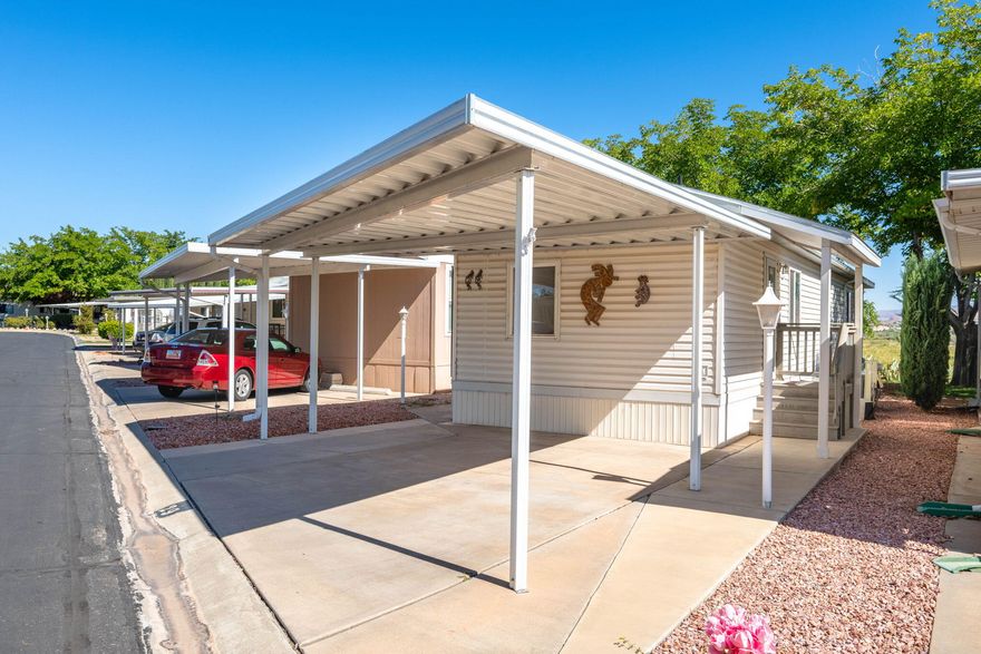 Cute and comfortable mobile home with some great updates and amazing views! In 2010, an addition was added with a roomy
living area, half bath, and hallway for extra space and comfort. You'll love spending time on the Trex deck, taking in the peaceful
views of the Virgin River and Zion National Park in the distance. This home has been well cared for and offers a quiet, relaxing
place to call home or enjoy as a weekend getaway. Ample storage built in, as well as a shed on the property plus an individually
assigned storage shed in the community.