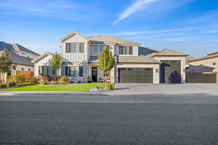 Welcome to a stunning home nestled in one of the most sought-after neighborhoods within the Crimson Cliffs High School boundaries. Designed with both luxury and livability in mind, this property features an exceptional backyard made for unforgettable memories — from family pickleball matches and basketball games to trampoline fun and relaxed evenings on the expansive patio. It's the perfect setting for barbecues, outdoor dining, and hosting the people you love. Step inside to discover generously sized bedrooms and a beautifully designed kitchen that truly feels like the heart of the home. With engineered hardwood flooring, high-quality appliances, abundant counter space, and