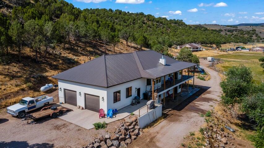 Beautiful mountainside mini ranch home on 10 acres. Enterprise, UT is a small rural farming town in Southern Utah. Only 40 minutes from St. George or Cedar City. Built in 2020 with 3,603sqft, 5 beds, 2.5 bath, large oversized 979 sqft 2 car garage, on 10.55 acres. Walkout basement. Open Floor Plan. Living room on main and family room in basement. Fireplace. Plenty of room for horses, animals, build a shop, barn, or stable. Enjoy coffee or cocoa on the deck. Nestled against the mountainside for privacy and with beautiful views all around. South property line backs to BLM land. Enterprise Reservoir is only 15 minutes away for fishing and boating. Lots of outdoor recreation. Close to restaurants, grocery, schools, medical, auto services, and hardware. Rural life with convenience. A must see.