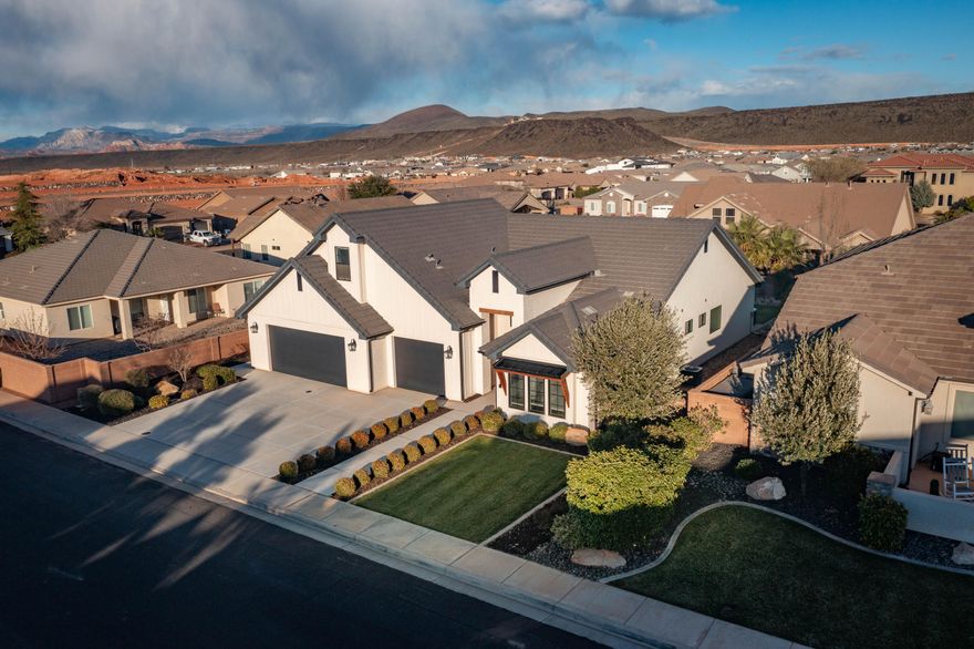 Built by a prominent Southern Utah builder for his own daughter, this exceptional residence reflects a level of care, craftsmanship, and structural integrity rarely found in today's market. 
The thoughtfully designed floor plan offers a clever separation between children's quarters and the primary suite, creating ideal privacy for multi-generational living, visiting guests, or simply a quiet retreat at the end of the day. The layout balances openness with defined spaces, delivering both connection and comfort.
The kitchen is appointed with premium Bosch appliances, offering both performance and refined design--perfect for everyday living or entertaining. Integrated surround sound enhances the ambiance, whether hosting gatherings or enjoying a quiet evening at home. Step outside to an east-facing backyard, thoughtfully oriented for shaded afternoons and comfortable outdoor living year-round. Relax in the private hot tub, utilize the dedicated dog run, or envision the future--there is ample room to design and build a custom pool, transforming this backyard into a true desert oasis.
The oversized garage provides generous space for vehicles, recreational equipment, and storage--ideal for those who enjoy the Southern Utah lifestyle of boating, off-roading, and outdoor adventure.
Located just minutes from Sand Hollow State Park, this home offers immediate access to boating, paddleboarding, fishing, hiking, and ATV trails--placing world-class recreation at your doorstep while maintaining the tranquility of residential living.
This is more than a home--it is a carefully built legacy property in one of Southern Utah's most sought-after recreation corridors.