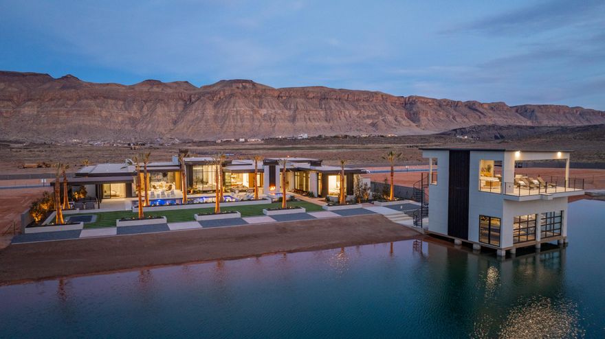 The Lake House at Southern Shores. Featured in the 2025 St. George Parade of homes. This modern design is situated perfectly for entertaining and enjoying the lakes at Southern Shores community. Features 5 en-suite bedrooms, well-ness room with sauna and cold plunge, pool and spa. Private boathouse to house 2 boats and entertain right by the lake, with our own private beach.