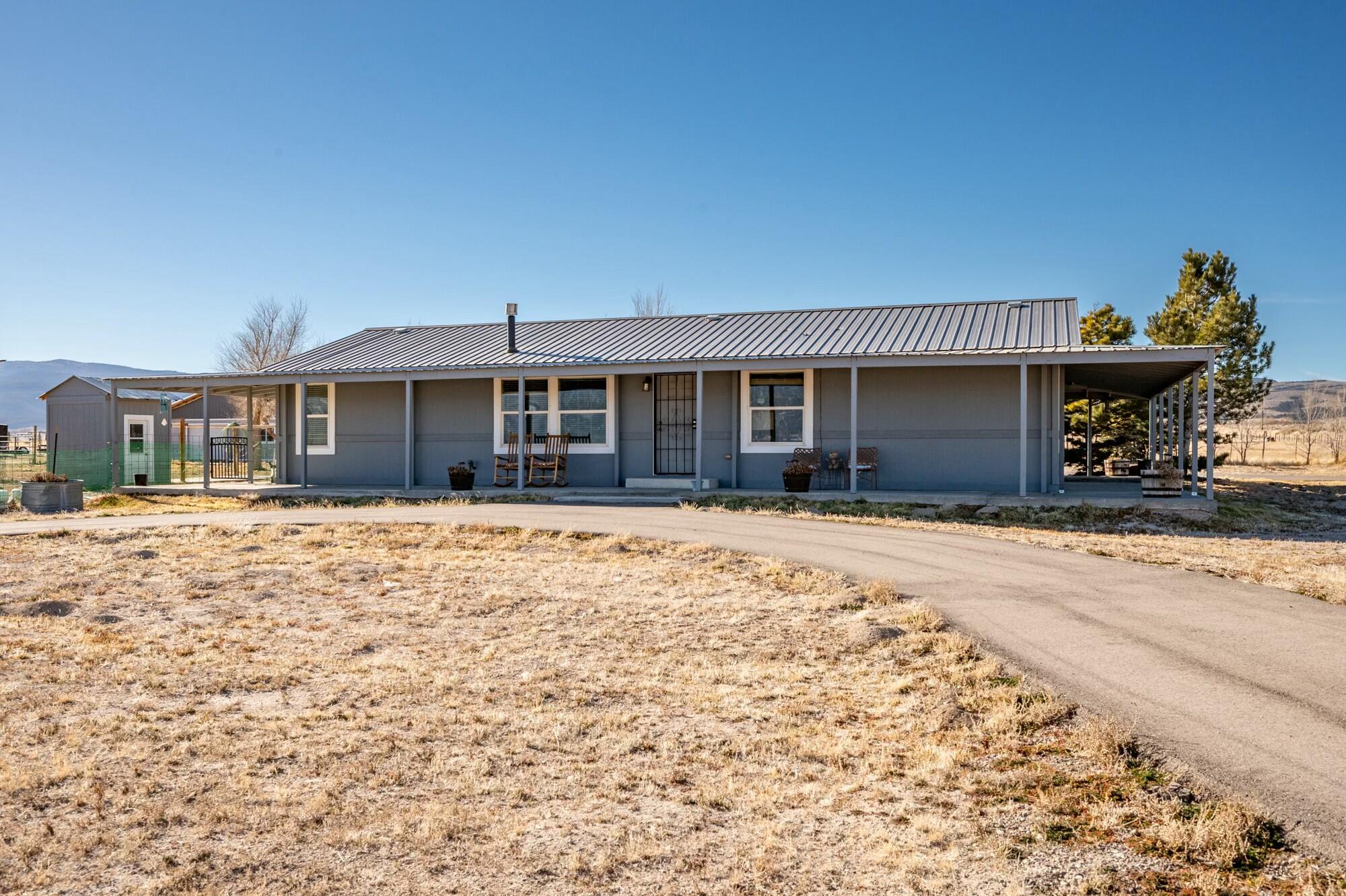 Come home to this peaceful rural retreat, just minutes from downtown Cedar City, UT. Situated on 7.25 acres, this 4-bed, 2-bath home offers nearly 1600 sq ft of living space, including a spacious master suite with a separate jetted tub and shower. Enjoy stunning views and ample shade from the full wraparound patio. The property features 2 acre-feet of water from a private well, solar & grid power, and full RV hookups with a dump station. A nearly 2,000 sq ft barn and two 53-ft con-ex boxes provide abundant storage. Bring your horses. Welcome Home!