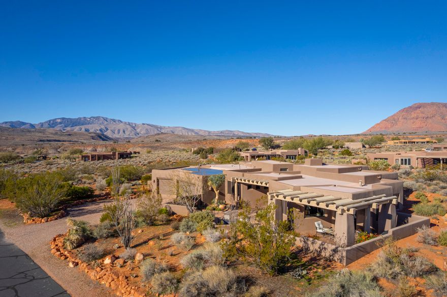 This custom former parade home (2003) has 3,077 square feet and sits on a generously-sized .73 acre lot on a corner lot on a quiet cul-de-sac in southern Utah's premiere desert community.  Built using a polysteel system that uses insulated concrete forms (ICFs) to build durable, energy-efficient and structurally-sound homes, this lovely home has 3 bedrooms and 2 bathrooms, a formal living area as well as a family room.   There's a gourmet kitchen (with high end SubZero, Wolf, and ASKO appliances), a built-in safe room, alarm system, solar panels, and built-in Murphy bed.  A large 175 square foot heated and cooled room off of the 3 car garage can be used  as a home office, workshop, art studio or home gym. The home has been restucco'ed by the current owners.  Quiet, peaceful, and secluded. Stunning views of towering red cliffs and endless sagebrush. 1280 Mochni is situated just a short 5-10 minute walk to the renowned Kayenta Art Village, with its art galleries, restaurants, shops, Center for the Arts, 25 meter swimming pool, and more!