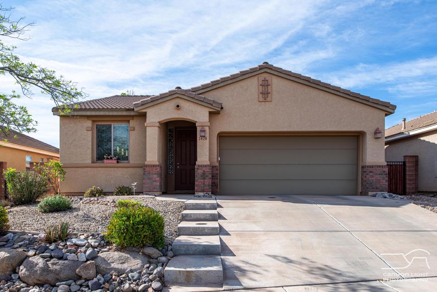 Welcome to this beautifully maintained single level home in the highly sought-after Coral Canyon community. This property offers the perfect blend of comfort, functionality, and access to Southern Utah's stunning outdoor lifestyle.
This well-cared-for home features a practical open floor plan, including a versatile third bedroom that can easily serve as a home office or den. Inside, you'll find beautiful LVP wood flooring and a spacious walk-in closet in the primary suite. The home is also pre-plumbed for a water softener, adding extra convenience. The kitchen and living areas flow seamlessly, creating an inviting space ideal for both relaxing and entertaining.
Step outside to a secluded backyard retreat, complete with a covered patio--perfect for enjoying quiet mornings or evening gatherings.
Located in a community celebrated for its nearby trails, biking, and hiking opportunities, residents also enjoy access to Coral Canyon amenities including a clubhouse, indoor and outdoor swimming pools, hot tub, fitness center, pickleball courts, monthly activities, and a local park--all within easy walking distance from the home. This property offers easy, low-maintenance living in one of the region's most desirable neighborhoods.
