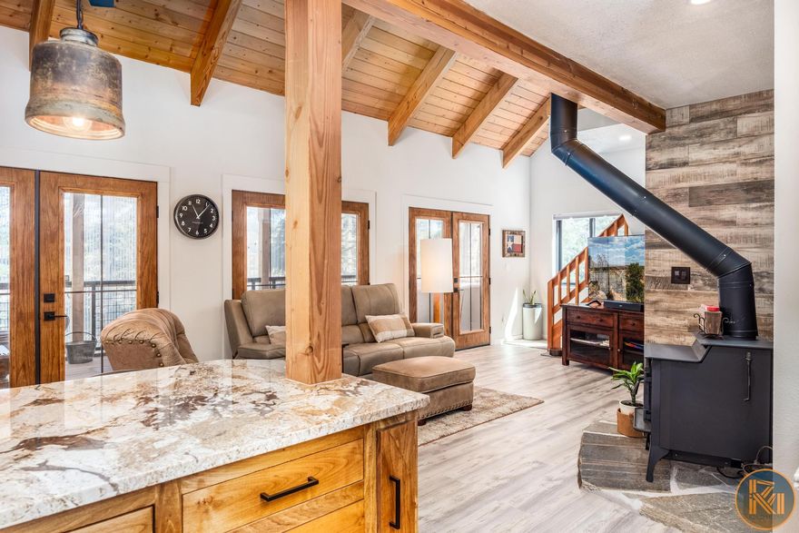 Tucked away on three combined lots totaling almost 2.5 acres, this beautifully modern cabin offers every convenience wrapped in a peaceful mountain setting. Bright, open, and thoughtfully designed, it's the perfect blend of style and comfort. One of the standout features is the stunning sunroom- a light-filled space ideal for morning coffee, cozy evenings, or simply soaking in the serene surroundings year-round. The new pull through 40x50 garage is equally impressive, featuring 100,000 BTU heaters, a private bathroom, a dedicated workshop area, and a spacious loft for storage, studio space, or more. Whether you're storing your toys, working on projects, or dreaming up your next adventure, this garage is ready! Since the photos were taken, a blacktop driveway and a retaining wall have been added, enhancing both functionality and curb appeal. For buyers looking to expand, the seller has thoughtfully had plans designed for an 800 sq ft addition - available for review if you're ready to take this already incredible property to the next level. Don't miss the chance to own a truly move-in ready modern mountain retreat with room to grow!