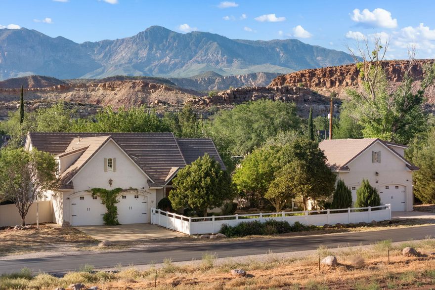 Tucked away in the secluded town of Leeds, just 10 minutes from St. George and 5 minutes from Quail lake, this half-acre property offers privacy, space, and a quiet setting on a peaceful street.
The home features a split floor plan with an open kitchen and great room, highlighted by beautiful beams for a warm, inviting feel. A new HVAC system and well-maintained roof provide added comfort and peace of mind. A sunroom  attached to the primary and ample storage add to the home's functionality.
With 4-car garage space (2 attached, 2 detached), there's room for vehicles, toys, or hobbies. Above the detached garage is a large, climate-controlled room with potential for a casita, guest space, or studio.
The yard offers mature shade, grapes, roses, pecans, and fruit trees, plus a covered patio and RV parking--ideal for animals, kids, or your own private retreat.