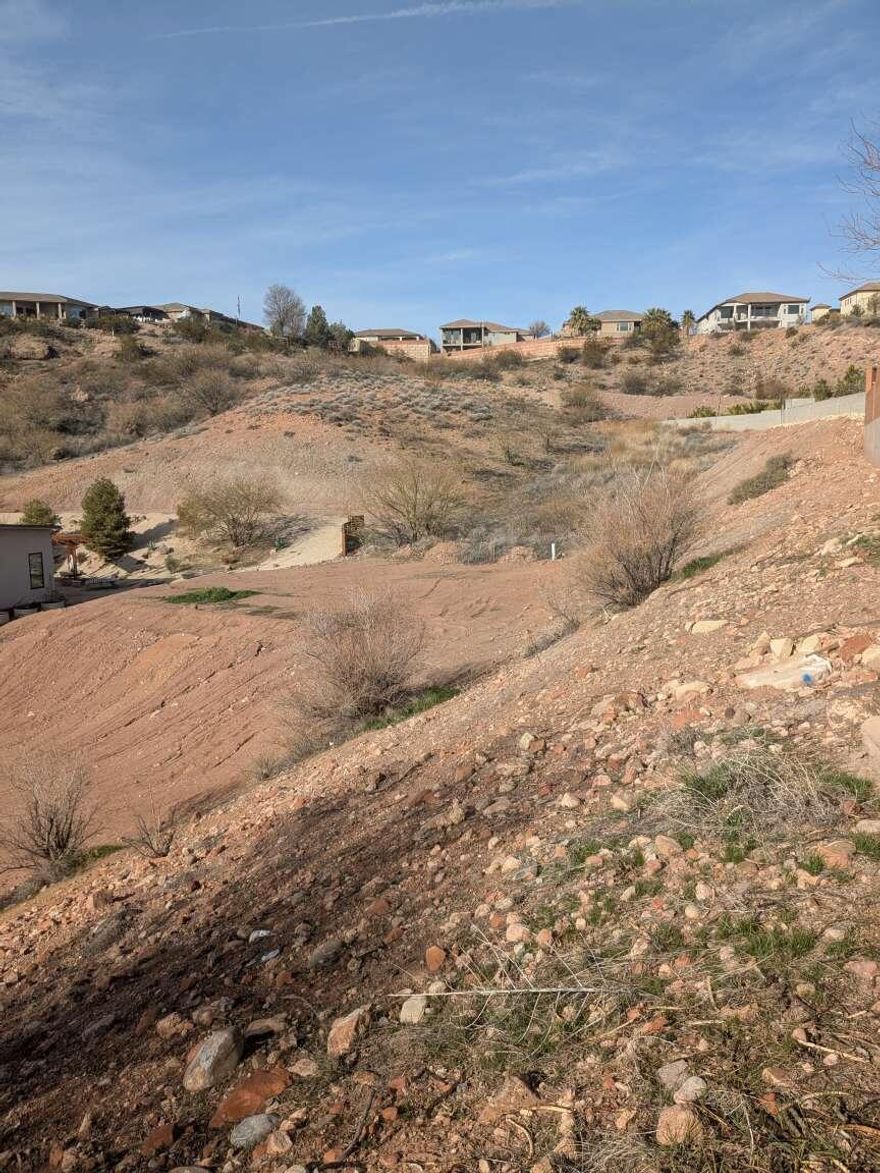 Price Reduced! Prime 0.23-acre lot in Overlook at Green Valley, now offered at an improved price. Ideally located at the end of a quiet cul-de-sac, this private and secluded lot has no neighboring homes directly on one side or behind, providing extra space and a peaceful setting. The lot is rectangular with paved road access, and all utilities are available (water, sewer, electric). Soil testing has been completed; pier foundation or excavation work required, making this a great opportunity for buyers prepared for a custom build. Low property taxes (~$220/year) and HOA dues of just $150/year in an established St. George neighborhood one of the last lots available. Well-suited for a custom home, builder, or investor seeking value and location. < Now priced at $158,000  recently reduced for a timely sale.