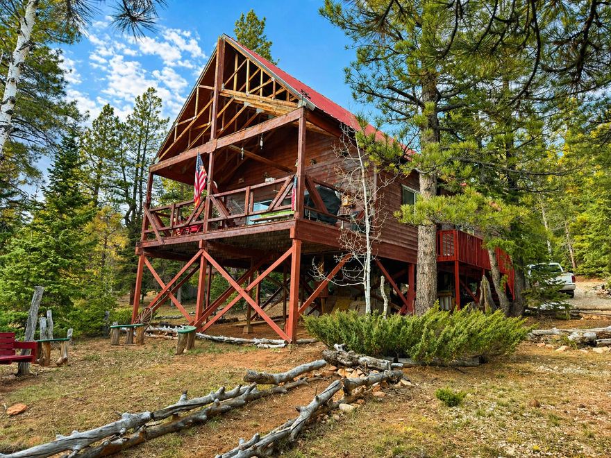 Escape to the mountains with this inviting 3 bedroom, 2 bathroom cabin nestled on a beautifully wooded 0.37-acre lot in Duck Creek Village. Located in the desirable Zion View Mountain Estates subdivision, this property offers the perfect blend of privacy, recreation, and comfort. Step inside to an open-concept floor plan designed for gathering and entertaining, with warm wood finishes that create a true cabin feel. The spacious loft provides additional sleeping space or a fun play area, making it ideal for hosting family and guests. Enjoy the outdoors from the deck overlooking the valley, where you can take in peaceful forest views and fresh mountain air. The lot offers plenty of room for outdoor activities, whether it's relaxing, exploring, or entertaining. Property features include: Septic system installed, Water meter installed, Solar power system in place
Power available at the street for future hookup. Whether you're looking for a weekend retreat, vacation rental, or full-time mountain getaway, this cabin delivers the ideal setting for quiet Mountain enjoyment.