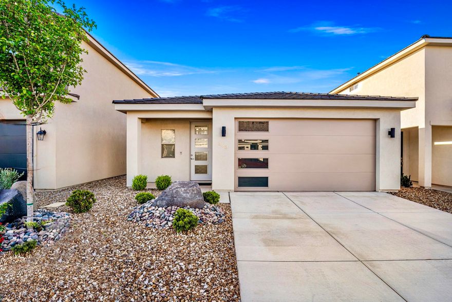 Picture yourself waking up in this stunning almost-new 2-bed, 2-bath home, then heading out to explore world-class recreation right in your backyard ! This meticulously maintained gem is your gateway to adventure--whether you're casting a line at Quail Creek's year-round warm waters, cliff jumping at Sand Hollow Reservoir, hiking the scenic Virgin River Trail System, or teeing off at nearby golf courses.

Inside, you'll love the beautiful waterproof LVP flooring that stands up to your active lifestyle, rich pecan cabinets, and a luxuriously upgraded master bathroom that feels like a spa retreat. All appliances are included--refrigerator, washer, and dryer--so you can move in and start living immediately. The spacious walk-in closet next to the laundry room and garage means all your gear and adventure equipment have a perfect home.

Unwind on your private enclosed back patio after a day of exploring nearby State and National Parks. The low-maintenance exterior landscaping gives you more time to enjoy what matters most--living the Southern Utah dream! Whether you're a first-time buyer ready to plant roots, seeking a sun-soaked second home, or embracing the retirement lifestyle you've earned, this charming single-level home delivers it all.

Location perfection: Close to schools, parks, shopping, endless biking/hiking trails and access to 2 nearby lakes!

BONUS: Powered by Dixie Power--with electricity rates 45% below the national average, you'll enjoy some of the lowest and most stable energy prices in the entire region!