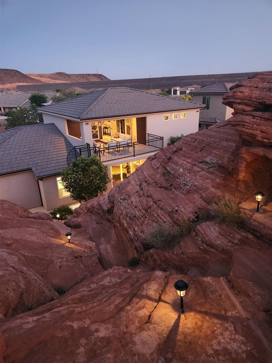 This extraordinary custom-built home is not just carved into the iconic Navajo sandstone�it's built around ''The Rock'' 
The architectural and natural mesh seamlessly blending elevated living with natural beauty of the Southern Utah. Included in this rare offering is a grandfathered, transferable nightly rental license�an invaluable asset, as the city is no longer issuing new licenses.

Designed for high utility and guest satisfaction, the floor plan offers the perfect balance of spacious indoor/outdoor living and guest accommodations. With the ideal bedroom-to-bathroom ratio and multiple gathering spaces, this home is tailored for maximizing both comfort and rental income potential.