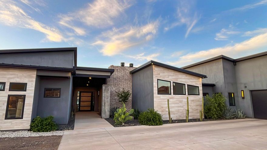 One of the most unique homes in the area. This gorgeous home has 4 bedrooms, 3 1/2 baths with open floor plan of 4,120 sq/ft. Large kitchen with double wall ovens and double dishwashers. Large walk-in pantry, drinking fountain and walk-in storage room. Built in 2020 with 3.73 acres of RA-1 zoning (residential agricultural zone intended for low-density residential development and small-scale agricultural activities). This is the ideal location for anyone wanting a hobby farm. There is a working well with 8.5 acre feet of agricultural water. This home sits on a hill with unobstructed views of pine valley mountain range, Zion National Park and Virgin River. Gas fire pit and trampoline with a covered patio for every epic sunset. Fully fenced grass area, and fully fenced corral. One of the most unique features is that all land East and Northeast is BLM land. You will have your own private access to BLM horse and walking trails, with no fear of anyone building around you to obstruct your views or encroach on your personal space. The 3.78 acres has been surveyed, and is ready for a 1-acre lot split if desired.
Don't miss out on this incredible property. You have easy access to Sand Hollow State Park, Snow Canyon State Park, and Zion National Park is only 30 minutes away. Two covered horse corrals will be left with the purchase of this home. The horse property is fully fenced with two gates, and is ready with the well and agricultural water to grow pasture grass. There is a 135 sq/ft walk-in safe. There is power already run down to the front gate at the entrance to the property, if a power gate is desired. Starlink will be left with the home. Sound system is set up for the entire home, plus driveway, side yard and backyard. The outdoor shower is just something you need to come and see. It's pretty amazing.