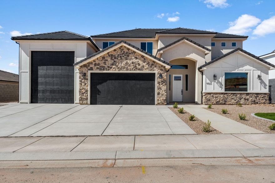 Live Where You Play - Scenic Luxury Living in Sand Hollow Village! This spacious home offers the perfect blend of comfort, convenience, and adventure. The luxurious primary suite features a spacious spa-like bathroom, oversized walk-in closet, and a convenient direct connection to the extra large laundry room. Upstairs, you'll find a large family room with a built-in kitchenette, perfect for guests, or movie nights. Step out onto the second-story deck to take in the panoramic views of Pine Valley mountain! All this with NO HOA! Ride from here to the lake or sand dunes and store all your adventure gear in the 41' RV garage! Use our preferred lender for a 1% buyer credit! All information is deemed reliable, but not guaranteed. buyer to verify all information.