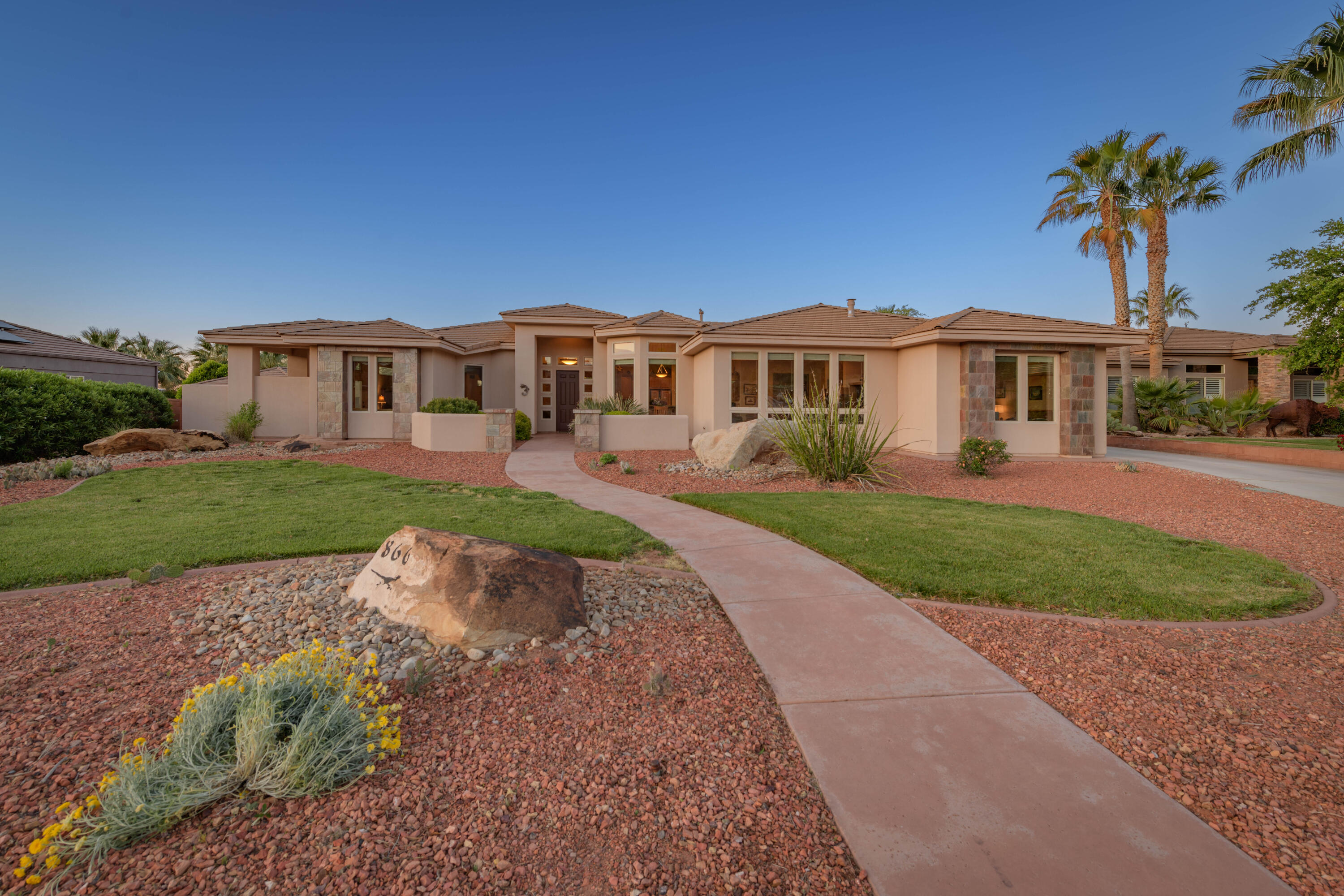 This unique home is located at the base of Snow Canyon State Park in the Chancel Cliffs community, offering rare views of Padre Canyon and Snow Canyon. Sitting on a .43-acre lot with no HOA, it provides ample space to customize the property to suit your vision. The well-planned layout includes a formal living room, a great room, a large master suite, a home office, and two guest rooms. With solar panels and a back up battery electric bills are minimal during the summer. Its location is ideal for enjoying the outdoors, with the Snow Canyon State Park entrance, bike trails, hiking, golf and more. Located minutes away from the new Black Desert Resort with world class amenities. Live where the world vacations.