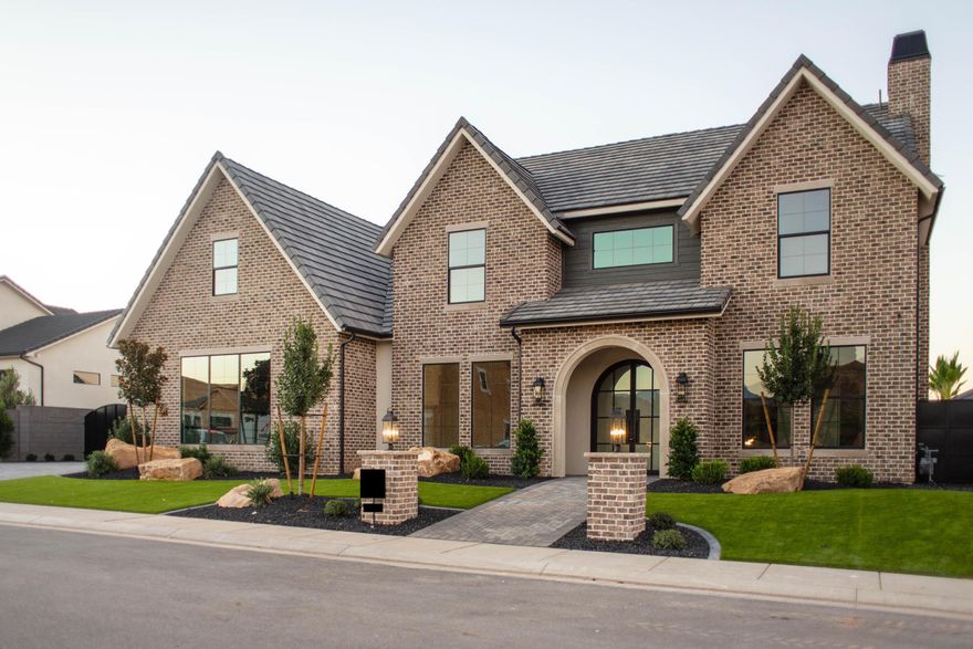 Brand-new custom home in Queensridge with incredible curb appeal. New-age brick exterior, paver driveway, and lighted posts at the sidewalk welcome guests. Turf, high-end landscaping, fencing, and gates are complete. Oversized garage includes side loader + oversized RV/boat bay. The backyard is built for fun, heated pool with shamu shelf, raised spa with waterfall edge, pickleball, volleyball, basketball hoop with light post, fire pit, turf, palm trees, in-ground trampoline, and a covered patio with surround sound. Inside: 7 bedrooms + office, 5.5 baths, 2 laundry rooms (one up, both with sinks), open kitchen/dining/great room, 2 dishwashers, tall entryway, engineered wood floors, custom millwork, tiled showers, custom cabinetry, and high-end finishes throughout.