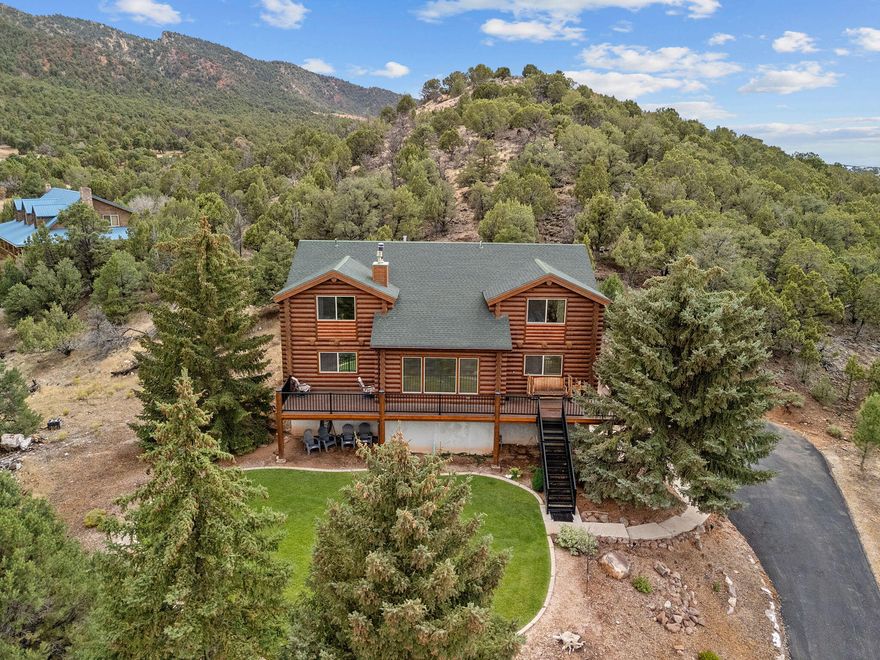 Nestled in the serene beauty of Parowan and just moments from majestic mountains, this exquisite 5-bedroom, 4.5-bath log home blends rustic charm with refined craftsmanship. Set on 1.24 acres of peaceful, private land, it's a perfect sanctuary for full-time living, weekend escapes, or a high-performing vacation rental. Inside, rich tile and woodwork create a warm, timeless feel. Surrounded by mountain vistas, the home is minutes from Brian Head skiing, Cedar Breaks, and Zion National Park. With furnishings included, it's rental-ready from day one. Don't miss your chance to own a slice of mountain paradise—schedule your private tour today!