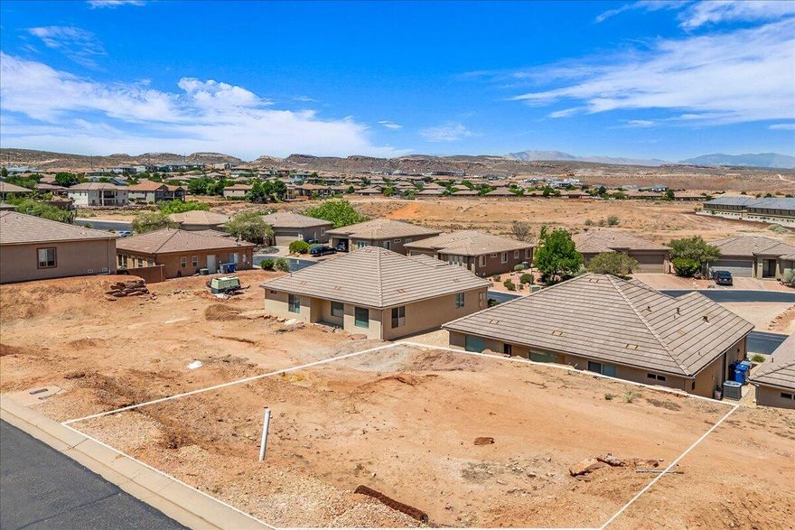 Bring your own builder! Discover the perfect opportunity to build on this improved residential lot located in the desirable Joshua Tree at SouthGate subdivision. Located just off of the 15th Fairway at SouthGate, Lot #13 offers stunning views of the surrounding red rock landscapes and Pine Valley Mountains, nestled in a quiet, established neighborhood. With nearby access to golf, hiking, biking trails, and the convenience of being minutes from shopping, dining, and downtown St. George, this location combines natural beauty with urban accessibility. *Square footage figures are provided as a courtesy estimate only. Buyer is advised to obtain an independent measurement.