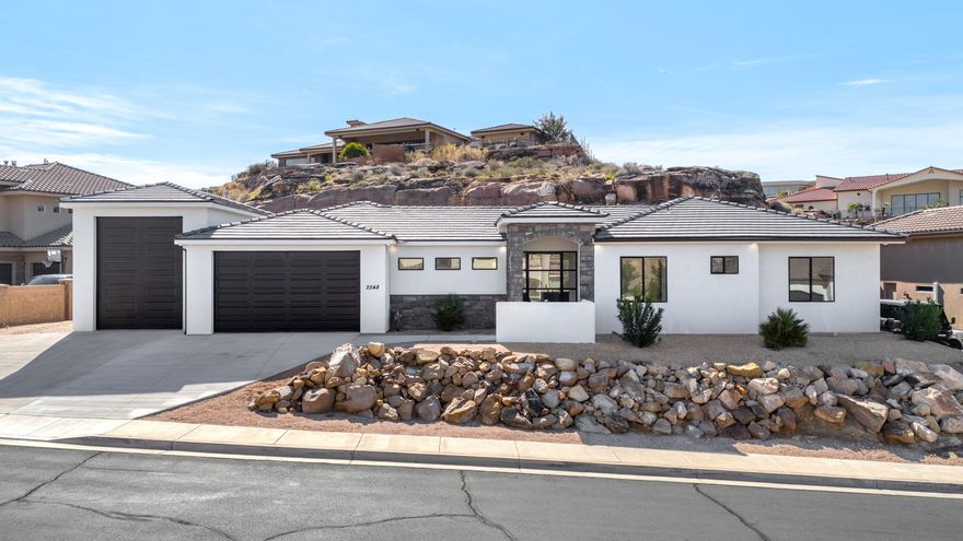 This charming 4-bedroom, 3-bathroom home offers comfortable living in a quiet, small neighborhood just minutes from vibrant downtown St. George. Primary Bedroom has washer/dryer hookups in the closet. There is also an additional en-suite bedroom/bathroom. The standout feature is the large RV garage (31'9'' deep x 13'7'' wide interior dimensions), with 240 Power Plugs. Perfect for your large rig, toys, or workshop, plus a separate two-car garage (24'8'' deep interior). Located in Dixie Power boundaries for reliable, affordable electric service (often lower rates than municipal options). No HOA. Owner/Agent