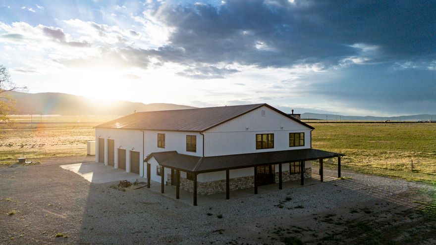 Experience the scenic, peaceful, small-town lifestyle of Southern Utah! Escape the city and live where the views stretch for miles. Set on 55 acres, this modern 2-story barndominium offers the perfect blend of freedom & function where you can create the life you've dreamed of. Step inside to enjoy a home filled with natural light, soaring ceilings, and windows that capture picture-perfect views. The expansive garage fits RVs, autos, or workshop needs - the ultimate man cave. Nearly 7,000 sq ft under one roof & expansive acreage gives room for your toys, animals, recreation, or agricultural pursuits. Located near Cedar City & abundant outdoor adventure, yet within driving distance of Las Vegas, Southern CA, & Salt Lake City. Come enjoy rural living with modern comfort and wide-open space! Offering 4 bedrooms and 2.5 bathrooms, or the flexibility of 3 bedrooms with a dedicated main-level office, this home is designed to adapt to your lifestyle while providing both comfort and functionality.

Step into the main living space and you'll immediately feel the scale and warmth that this home has to offer. Elevated ceilings paired with an abundance of windows flood the space with natural light and capture the amazing views outside. A cozy gas fireplace anchors the living room, while the seamless flow into the kitchen makes the space ideal for both everyday living and entertaining. The kitchen is thoughtfully designed with custom wood cabinetry, quartz countertops, a decorative vent hood, and a stylish backsplash. You're sure to appreciate the large center island providing additional prep space, storage, and seating, as well as the hidden walk-in pantry. Just off the main living area, there is a natural space for a dining table that ties everything together.

The main-level master suite provides a private retreat with convenience and comfort in mind. The ensuite bath features tile flooring, dual sinks, a soaking tub, and a separate tile shower--creating a spa-like environment to unwind at the end of the day.

Upstairs, a versatile bonus space offers flexibility for a media room, play area, or additional gathering space.

The garage is a true standout feature, designed for both function and enjoyment. With an RV pull-through configuration, it easily accommodates larger vehicles, trailers, and equipment. Two 150,000 BTU gas heaters, commercial-grade lighting, and blown-in and netted insulation keep the space comfortable year-round. A loft area provides additional room for hobbies, storage, or even a "man cave", while built-in mudroom storage and a convenient half bath add everyday practicality.

Additional features include dual-zone A/C and energy-efficient insulation in the home for year-round comfort, as well as a 26 kW backup generator to provide peace of mind.

Outside, the property is fully fenced for livestock, with approximately 2 acres separately fenced for a yard space surrounding the home. The expansive 55 acres offer unmatched flexibility for animals, recreation, or future improvements. Two wells service the property, including a 300-foot culinary well tested at 95 GPM, along with a secondary livestock well.

Despite its peaceful, rural setting, the property remains easily accessible, offering the best of both worlds--quiet, open space without sacrificing convenience to nearby amenities.

This is more than just a home--it's an opportunity to own space, freedom, and a lifestyle that's increasingly hard to find.