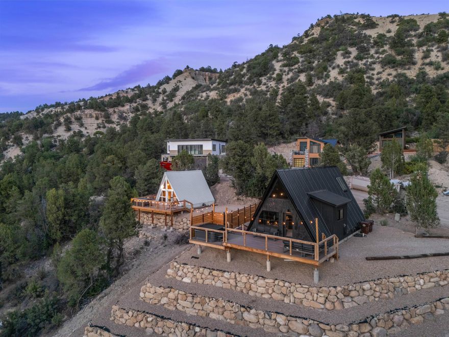 Great Rental Property!

Welcome to Zion A-Frames,-- a rare and captivating investment opportunity nestled in the heart of Southern Utah's red rock country. Located at 360 E Overlook Lane in Glendale, this unique property offers a blend of modern design, rustic charm, and unbeatable proximity to some of the region's most iconic landscapes.

These striking A-frame cabins are thoughtfully designed to maximize both comfort and visual impact, featuring soaring ceilings, expansive windows, and warm natural finishes that bring the outdoors in. Building 1 is two stories with a total of 784 sf and building 2 is 345 sf (1129 sf). Each unit offers an inviting open-concept layout, cozy sleeping lofts, stylish kitchens, and spa-inspired bathrooms.

Set against a backdrop of breathtaking canyon views and star-filled skies, Zion A-Frames provide a peaceful retreat just a short drive from Zion National Park, Bryce Canyon, and countless hiking, biking, and off-road trails. The property is ideally suited for use as a high-performing short-term rental or boutique hospitality concept

Guests and owners alike will appreciate the serene setting, modern amenities, and the sense of seclusion without sacrificing accessibility. Whether you're an investor looking to capitalize on Southern Utah's booming tourism market or a visionary seeking a one-of-a-kind property, Zion A-Frames delivers on every level.
Zoning R-M-7
Buyer to Verify