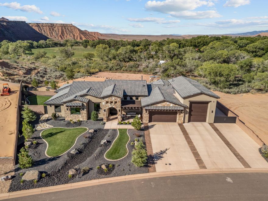 Nestled along the Virgin River on 1.31 acres, this custom home offers a unique blend of luxury and privacy, with breathtaking 360-degree views of Zion, Kolob, Smith Mesa, and Pine Valley Mountain. Built with top-of-the-line materials and craftsmanship, the home is designed for both comfort and efficiency, featuring Mont Blanc Quartzite and engineered wood throughout, along with &#8541; sheet rock and upgraded insulation for optimal soundproofing and energy savings. Inside, the open-concept floor plan is highlighted by a chef's kitchen with a 48-inch Wolf range and select grain-matched walnut cabinets. The living and primary bedroom feature stunning floor-to-ceiling tiled fireplaces, adding warmth and elegance. Each bedroom includes a spacious walk-in closet, and the gym,

already plumbed for a bathroom, offers flexibility for a second master suite or a private casita. Modern conveniences like Anderson low-E windows, a power shade, and a TV mount in the living room that moves for viewing ease further enhance the home's thoughtful design.

The outdoor space is equally impressive, with a heated, covered pool, over 1,000 sq. ft. of covered patio, and multiple fire pitsboth gas and woodsurrounded by paver benches. The beautifully landscaped backyard includes artificial turf, fruit trees, and a garden box, all fully fenced for pets. There's also plenty of space for a pickleball court or shop, adding limitless possibilities to this one-of-a-kind property.

Additional features include a commercial-grade fire suppression system, radiant barrier insulation, a whole-house water filtration system with a water softener, a split unit in the gym, and an epoxy-coated garage floor with storage in the loft. This riverside retreat combines the best of modern living with the beauty and tranquility of its natural surroundings.